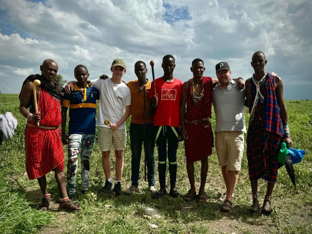 Group standing together in a field during the documentary trip in Kenya